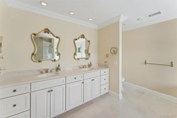 a bathroom with a double vanity sink and mirror