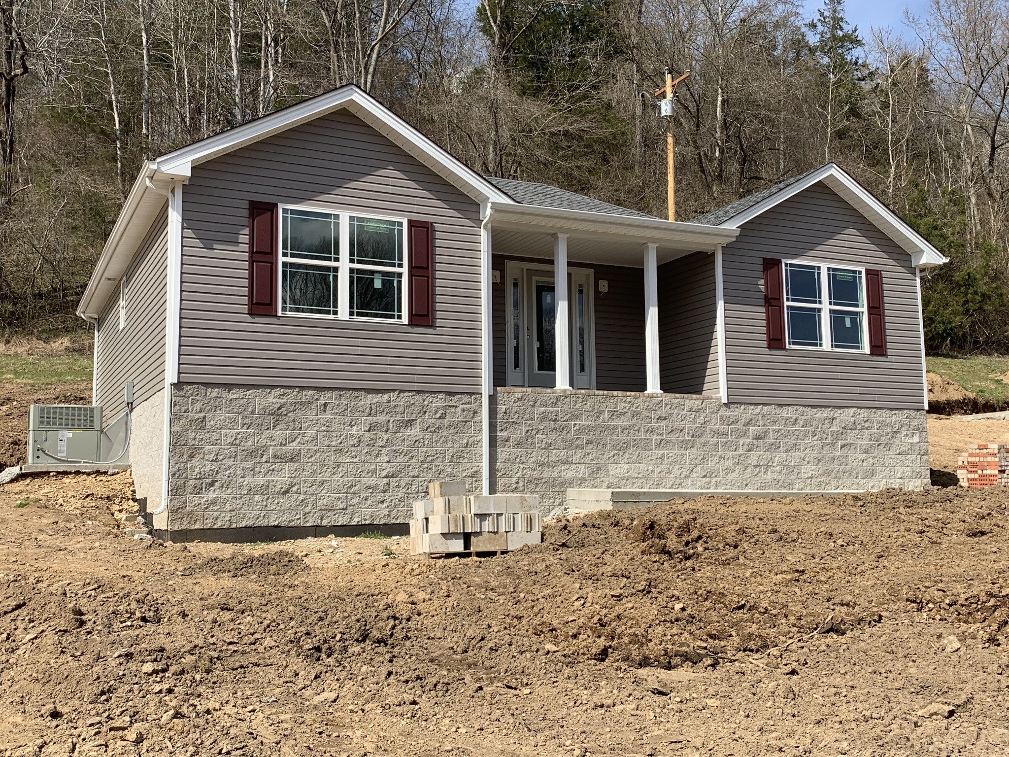 388 Leo Whitley Road Lafayette, TN 37083 - Photo 1 of 10 a front view of a house with a yard and garage