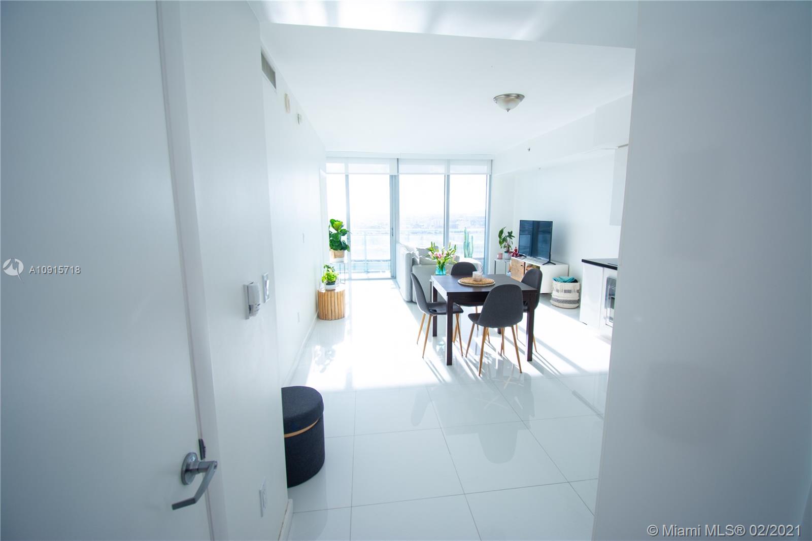 92 Southwest 3rd Street, Unit 2307 Miami, FL 33130 - Photo 11 of 18 a dining room with furniture and a floor to ceiling window