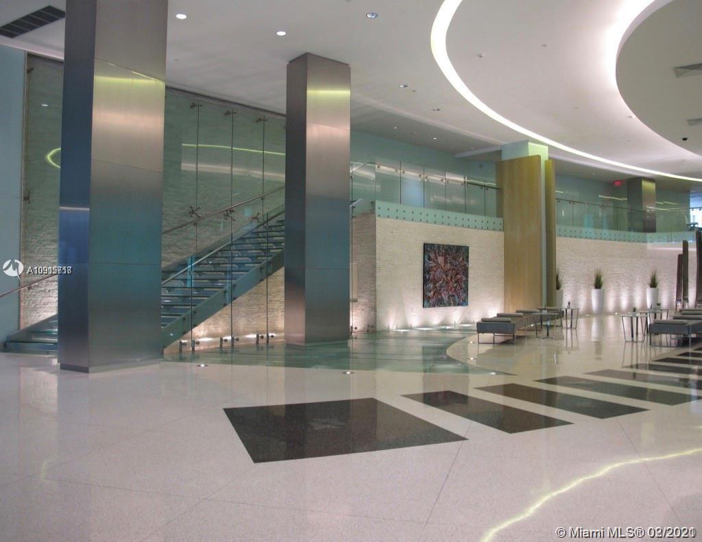 92 Southwest 3rd Street, Unit 2307 Miami, FL 33130 - Photo 14 of 18 a view of a lobby with a living room and glass door