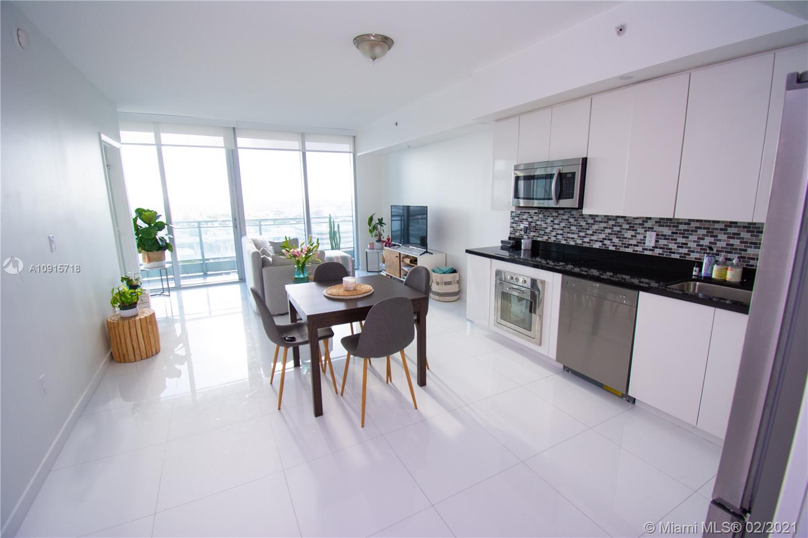 92 Southwest 3rd Street, Unit 2307 Miami, FL 33130 - Photo 3 of 18 a dining room with furniture and a floor to ceiling window
