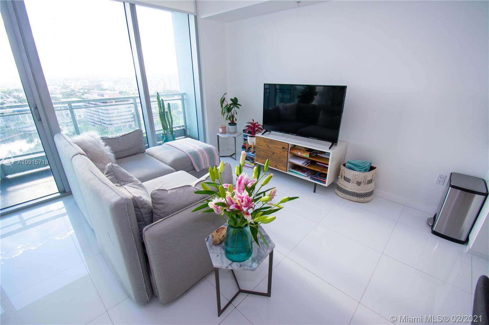 92 Southwest 3rd Street, Unit 2307 Miami, FL 33130 - Photo 5 of 18 a living room with furniture fireplace and flat screen tv
