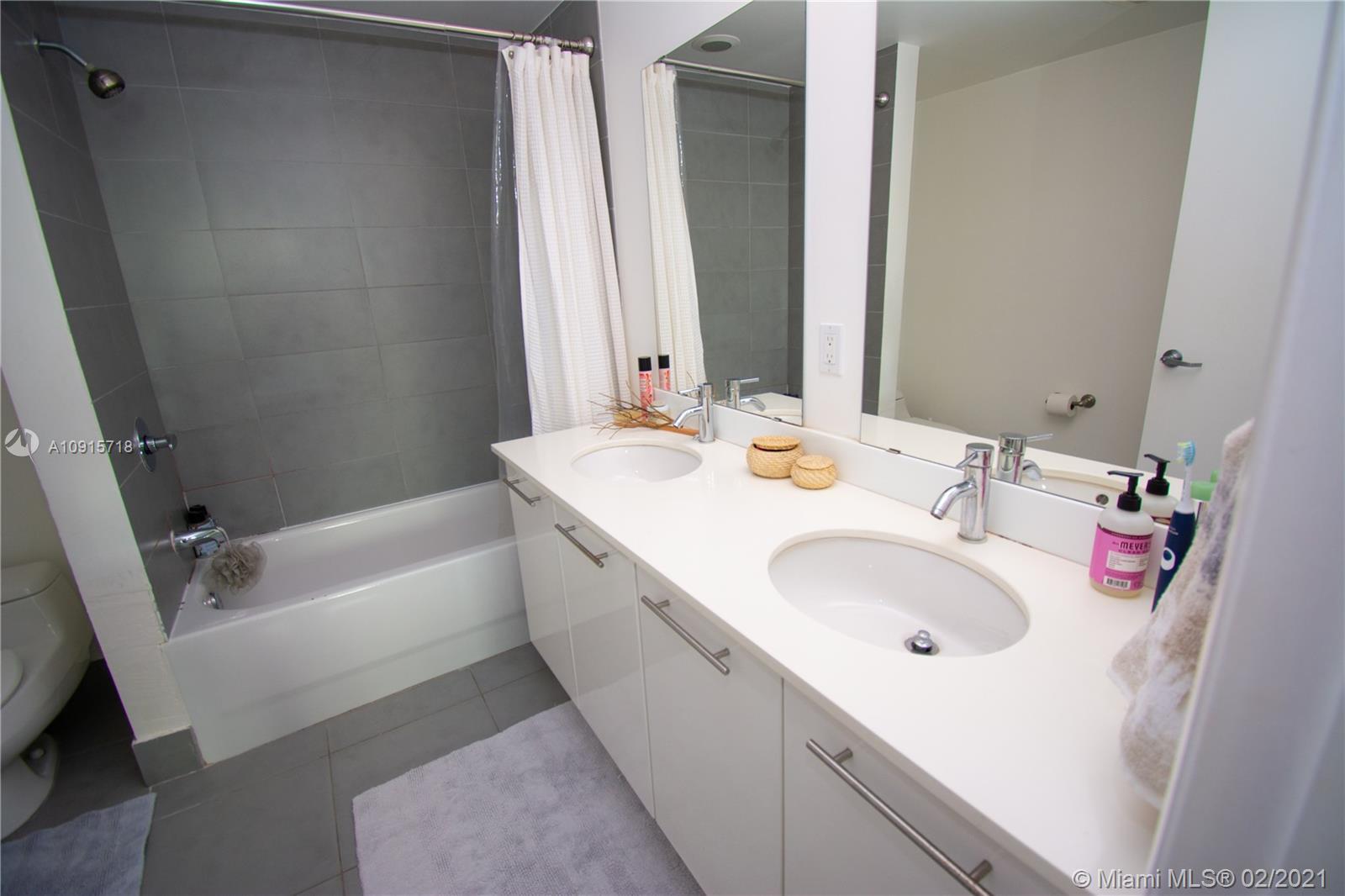 92 Southwest 3rd Street, Unit 2307 Miami, FL 33130 - Photo 6 of 18 a bathroom with a sink and a bathtub