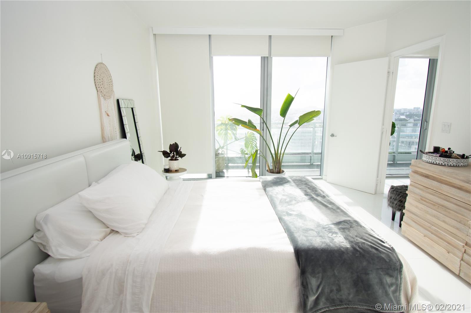 92 Southwest 3rd Street, Unit 2307 Miami, FL 33130 - Photo 7 of 18 a bedroom with a bed and a large window