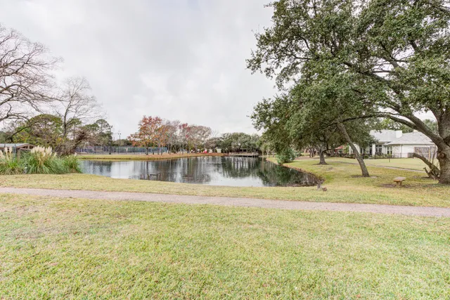 a view of a lake with houses in the background