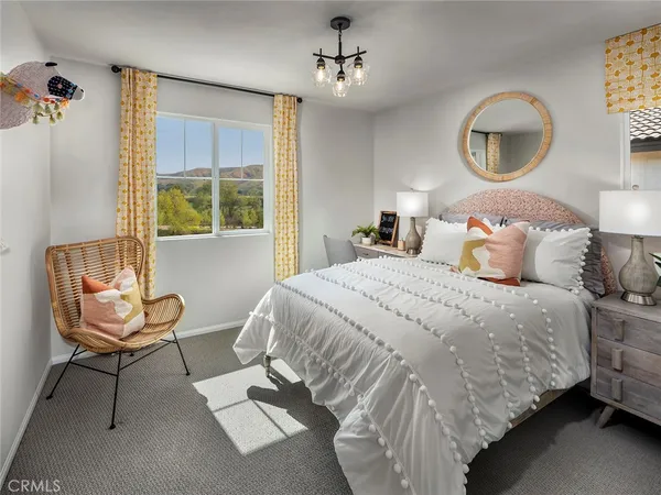 a view of a bedroom with furniture and windows