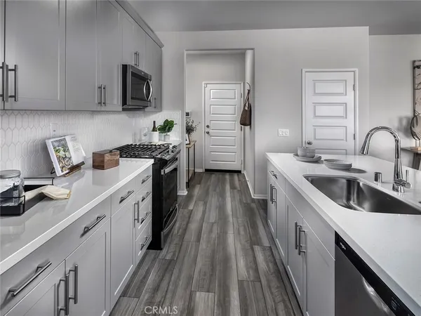 a kitchen with a sink cabinets and stainless steel appliances