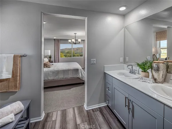 a en suite bathroom with a granite countertop sink and a mirror