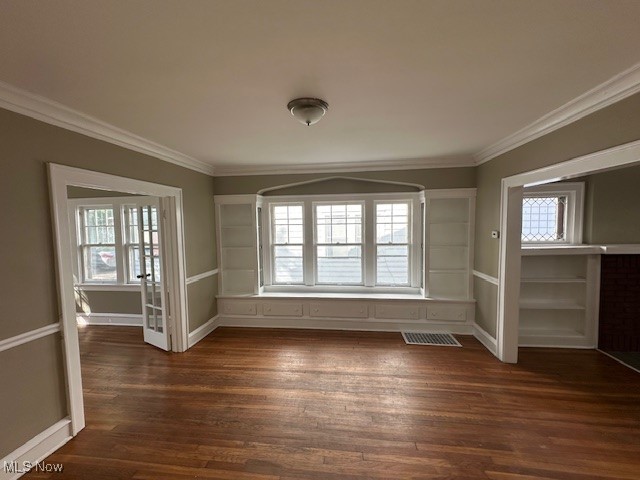 3282 Yorkshire Road Cleveland, OH 44118 - Photo 5 of 33 Empty room with a healthy amount of sunlight, ornamental molding, and dark hardwood / wood-style floors