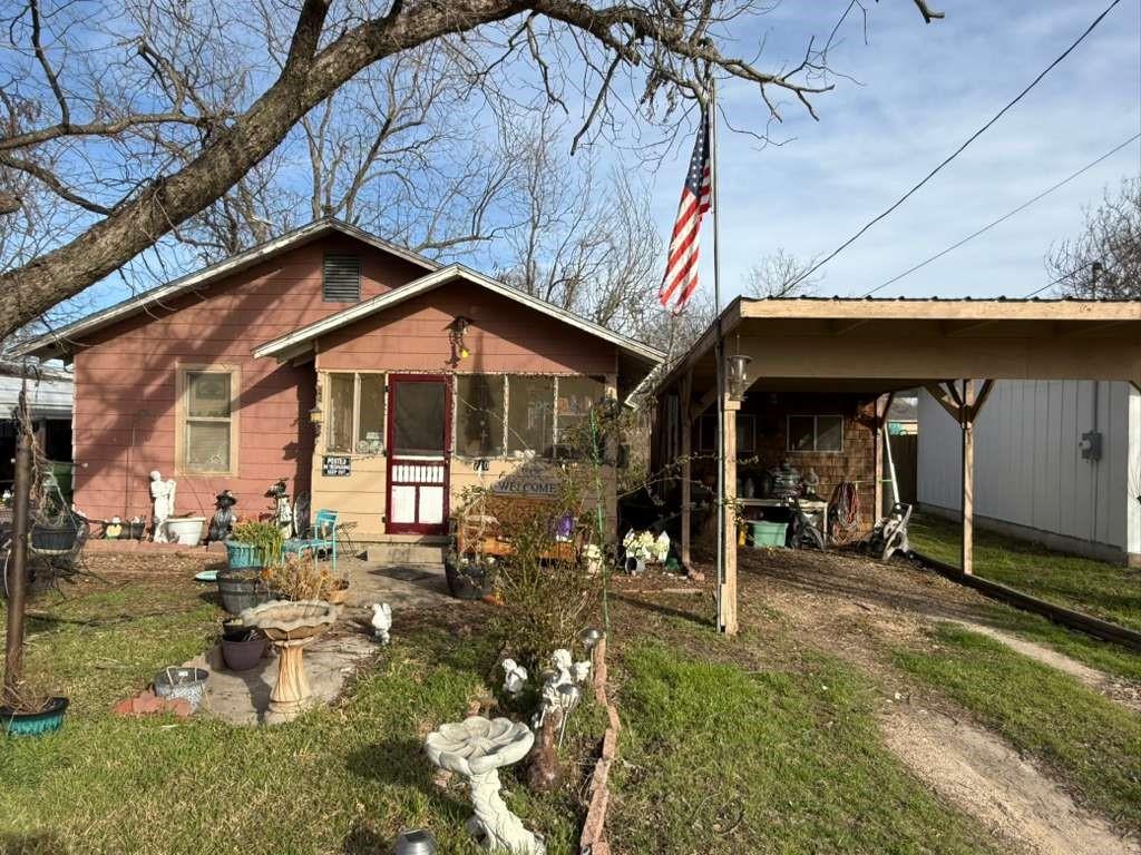 710 Whitney Street Morgan, TX 76671 - Photo 18 of 23 Rear view of property with a patio area, a yard, dirt driveway, and a carport