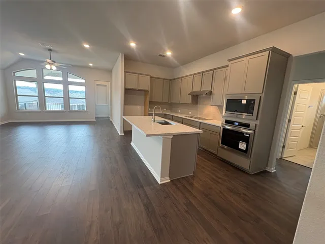 an empty room with a fireplace and windows