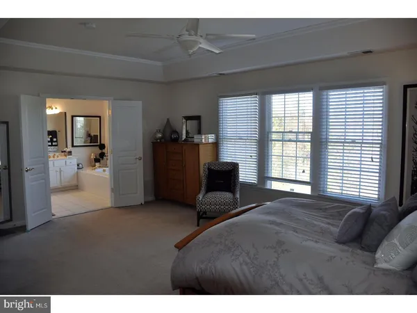 a living room with furniture and large windows
