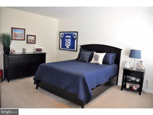 a bedroom with a bed and a night stand