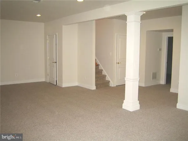a view of an empty room with a fireplace
