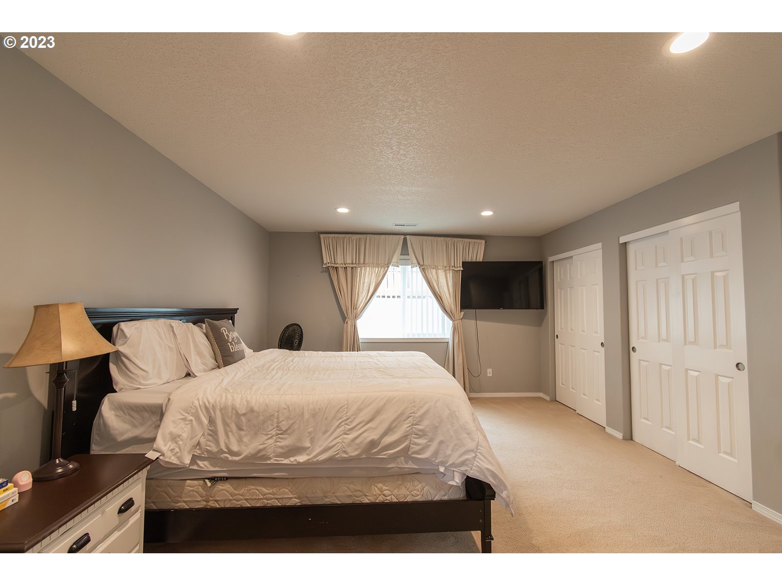 3148 South 3rd Way Ridgefield, WA 98642 - Photo 18 of 27 a bedroom with a large bed and a chandelier