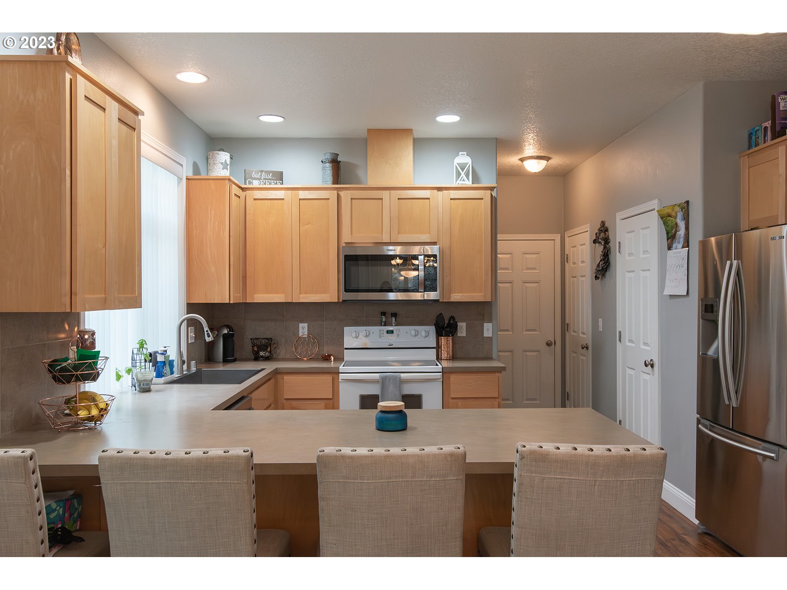 3148 South 3rd Way Ridgefield, WA 98642 - Photo 8 of 27 a kitchen with kitchen island a sink stainless steel appliances and cabinets