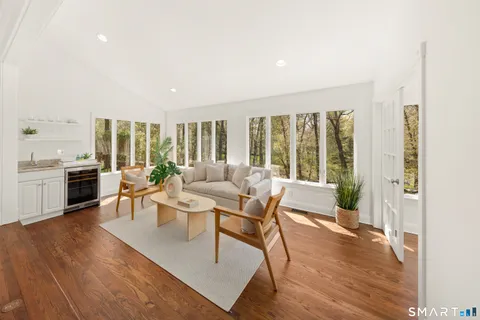a living room with furniture and large windows