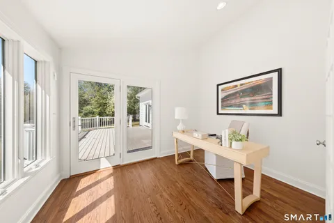 a living room with furniture a table and a large window