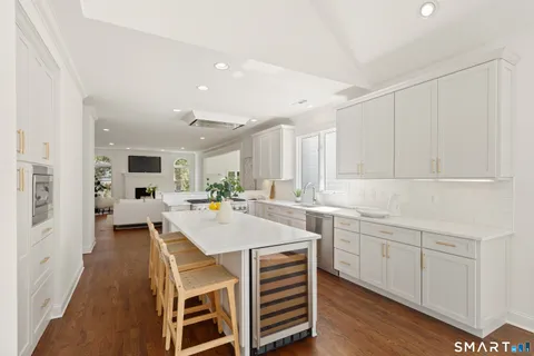 a large white kitchen with a large window