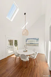 a view of a dining room with furniture window and wooden floor