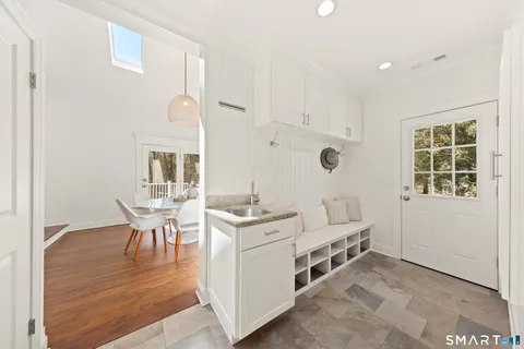 a living room with furniture a dining table and a window