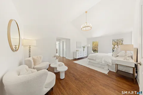 a bedroom with furniture and a wooden floor