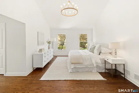 a spacious bedroom with a bed and a window