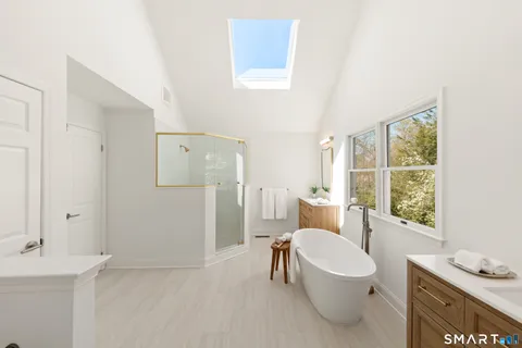 a white toilet sitting next to a bathroom sink