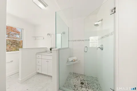 a bathroom with a sink and mirror with toilet