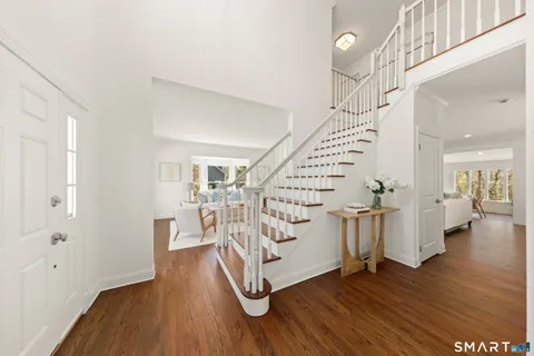 a view of an entryway with wooden floor and stairs