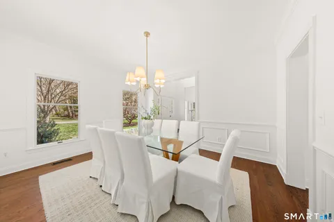 a view of a dining room with furniture window and wooden floor