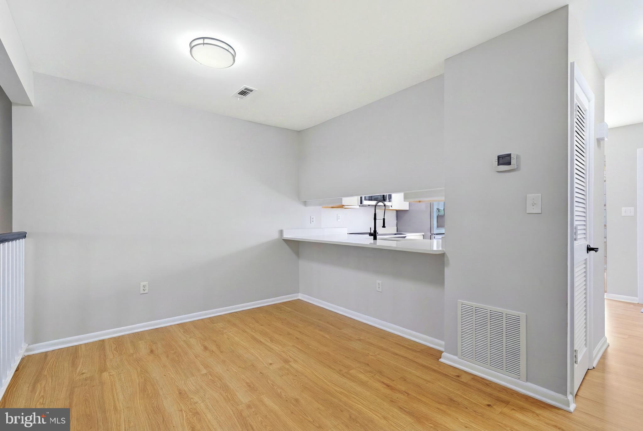 3682 Masthead Trail Triangle, VA 22172 - Photo 14 of 53 a room with a wooden floor and shelf