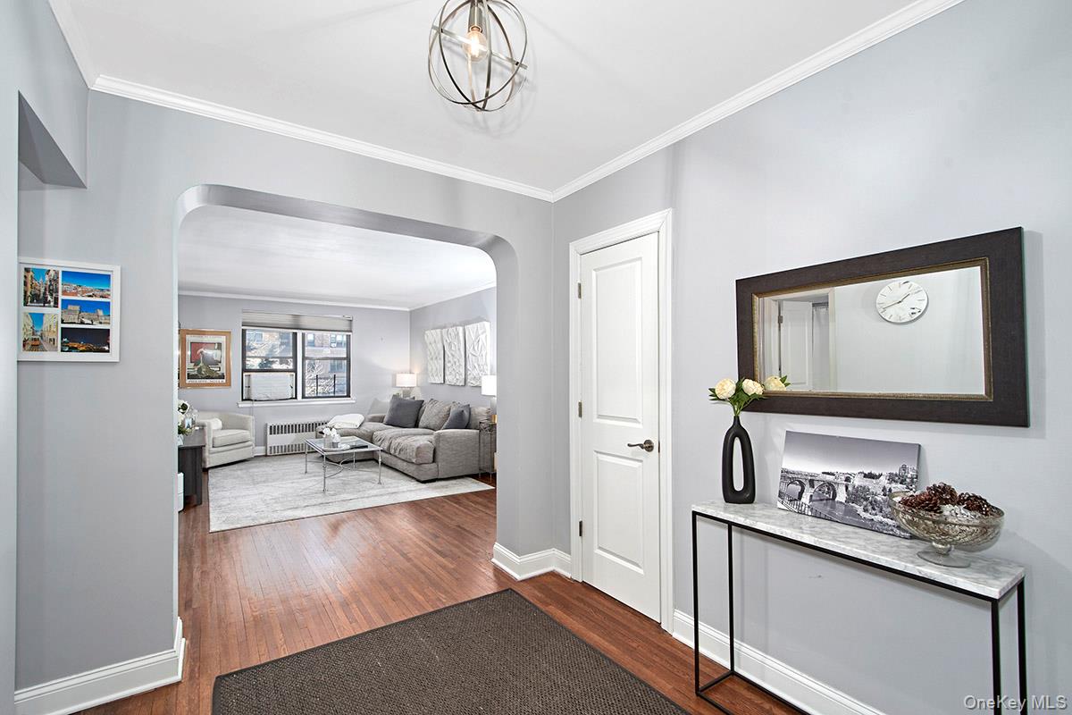 142 Garth Road, Unit 2M Scarsdale, NY 10583 - Photo 2 of 12 a living room with furniture and a flat screen tv