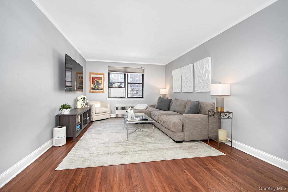142 Garth Road, Unit 2M Scarsdale, NY 10583 - Photo 4 of 12 a living room with furniture and a wooden floor