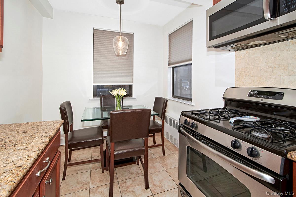 142 Garth Road, Unit 2M Scarsdale, NY 10583 - Photo 6 of 12 a kitchen with a stove and a table