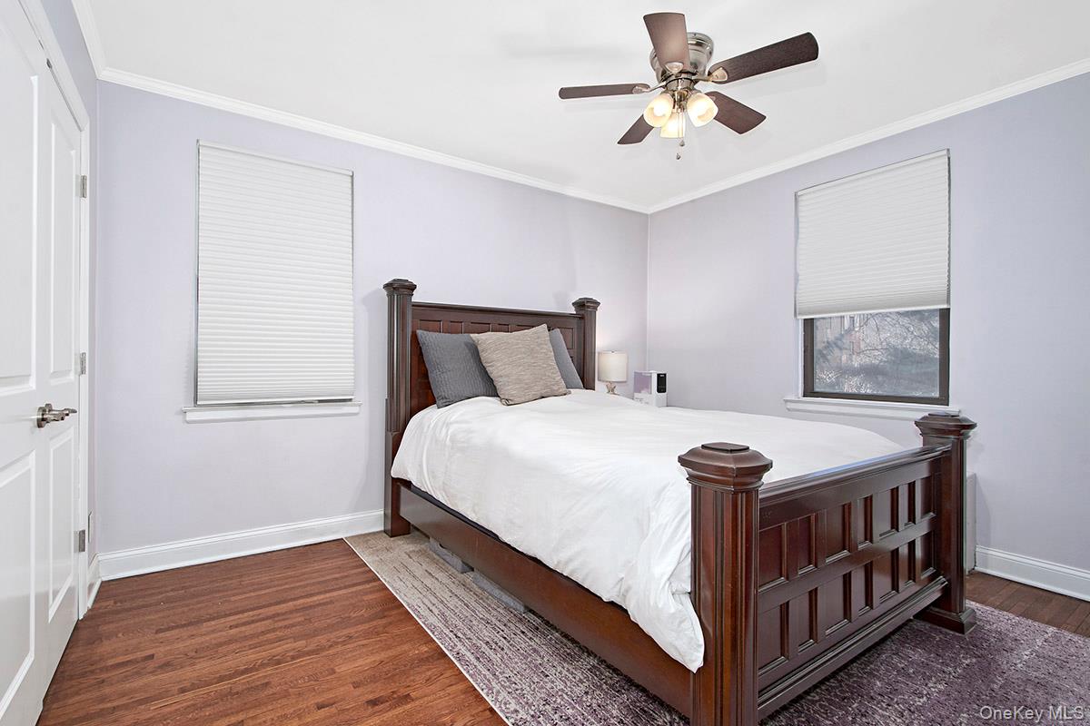 142 Garth Road, Unit 2M Scarsdale, NY 10583 - Photo 9 of 12 a bedroom with a bed and a window