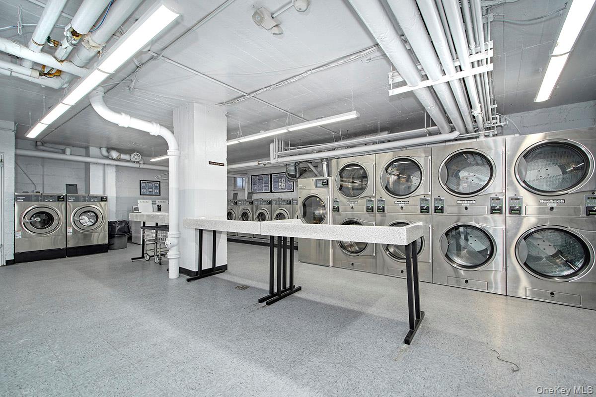 142 Garth Road, Unit 2M Scarsdale, NY 10583 - Photo 10 of 12 a utility room with multiple dryer and washer