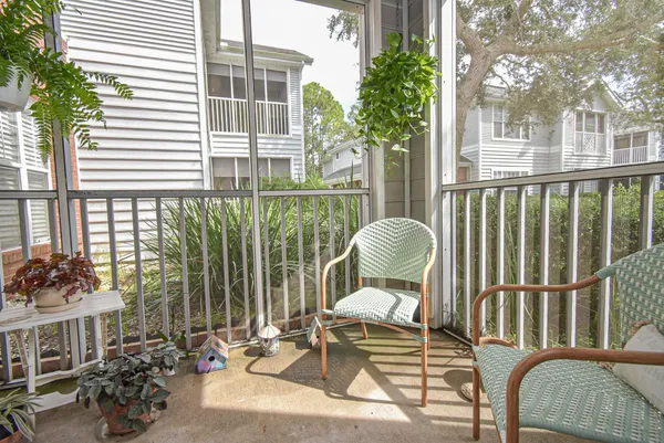 a view of an empty room with a window and a kitchen