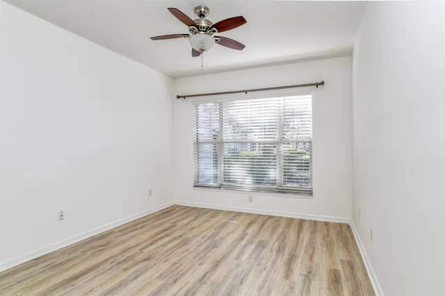a view of a swimming pool with a garden and patio