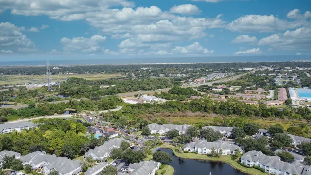 a view of a livingroom with furniture and floor to ceiling window