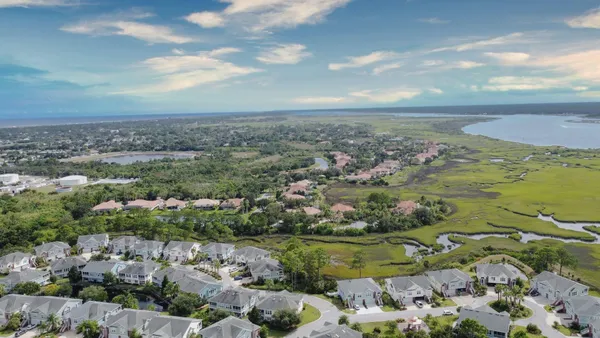 a view of a house with a swimming pool and sitting area