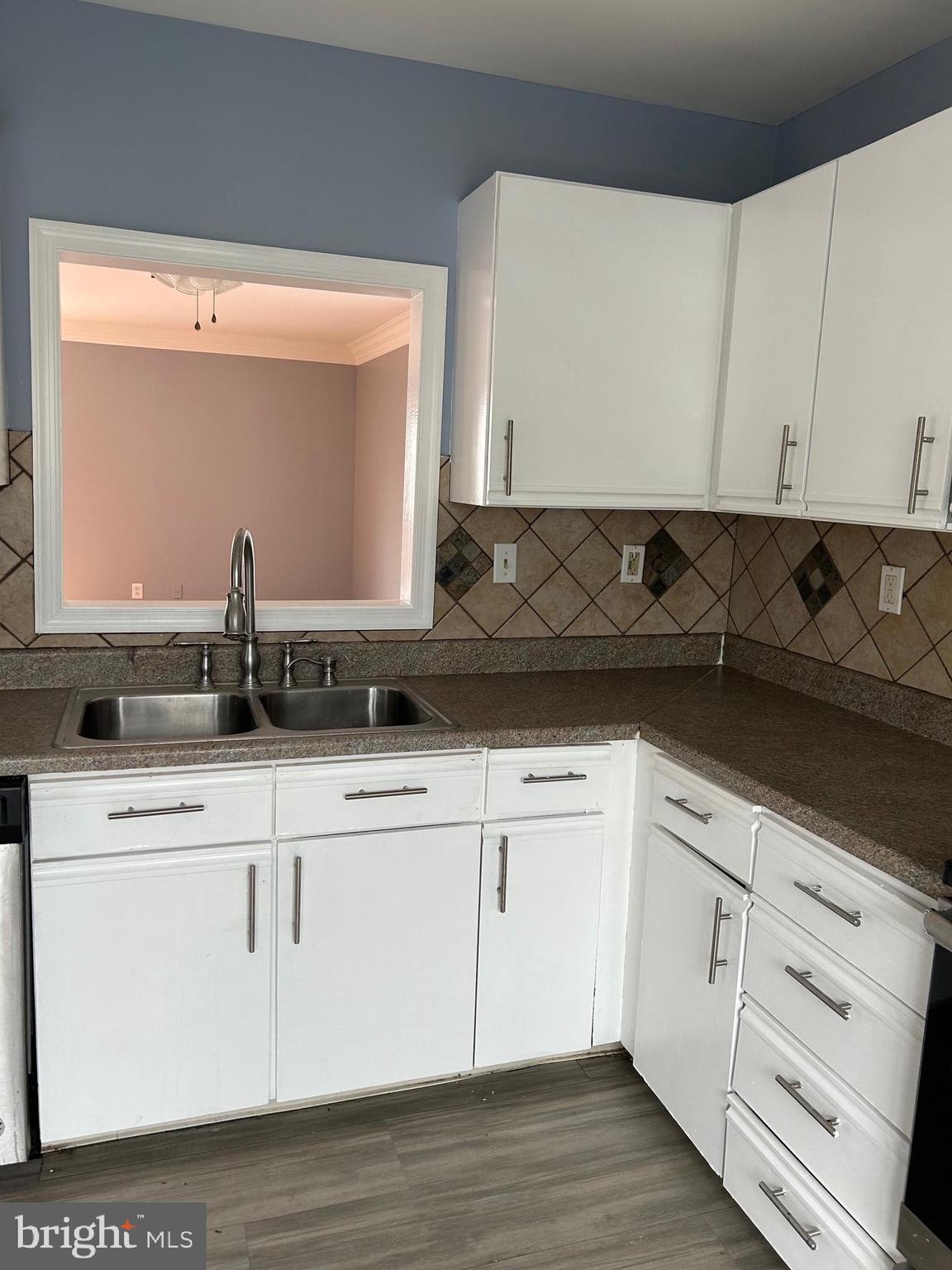 332 Cold Spring Place Dover, DE 19904 - Photo 3 of 10 a kitchen with white cabinets and sink