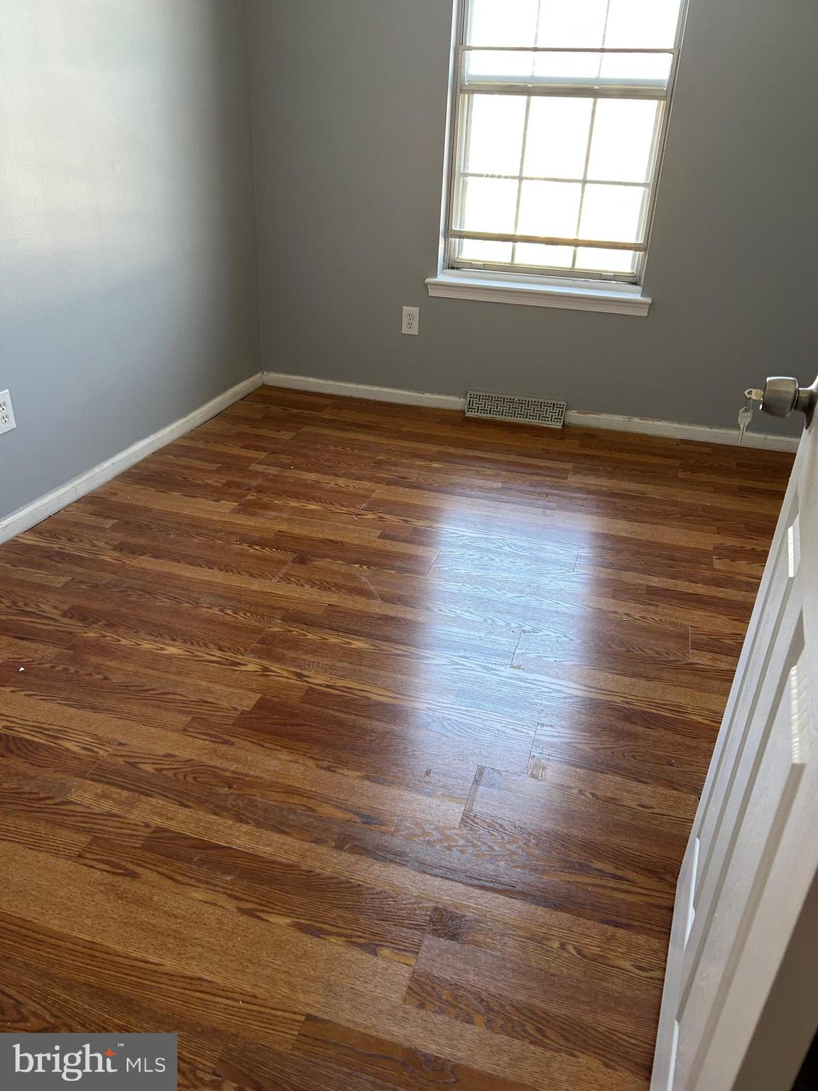 332 Cold Spring Place Dover, DE 19904 - Photo 6 of 10 an empty room with wooden floor and windows