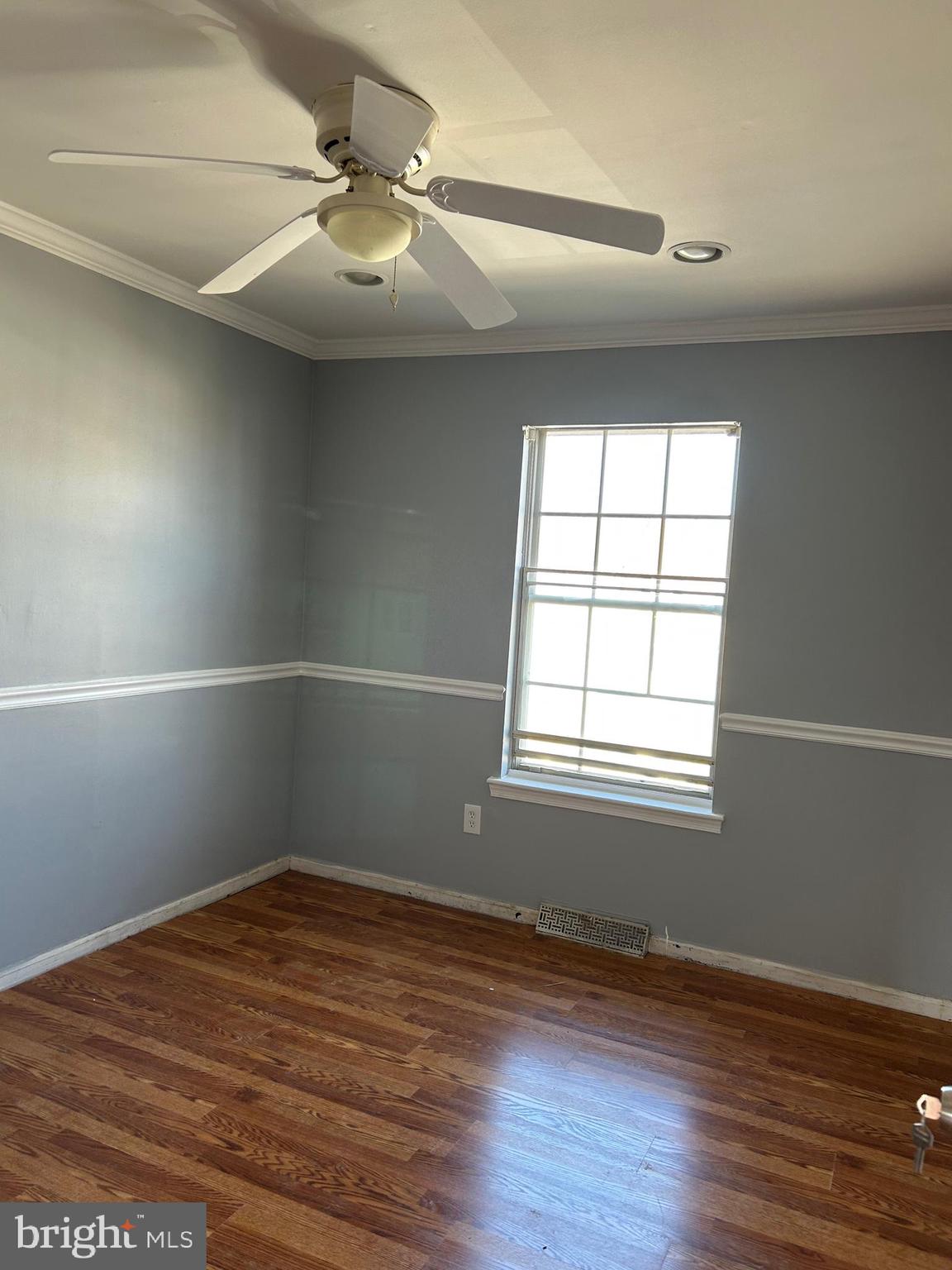 332 Cold Spring Place Dover, DE 19904 - Photo 7 of 10 an empty room with wooden floor and windows