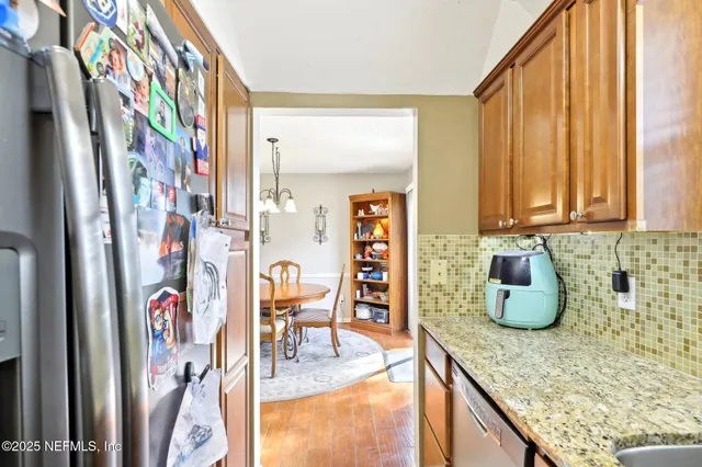 a kitchen with stainless steel appliances granite countertop a sink and cabinets