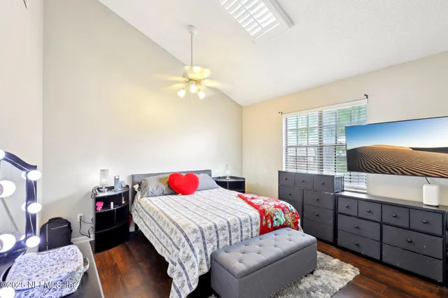 a bedroom with a bed and a chandelier