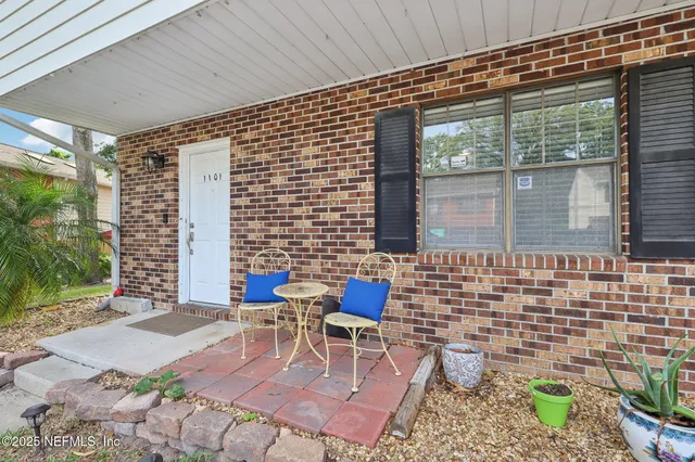a backyard of a house with outdoor seating