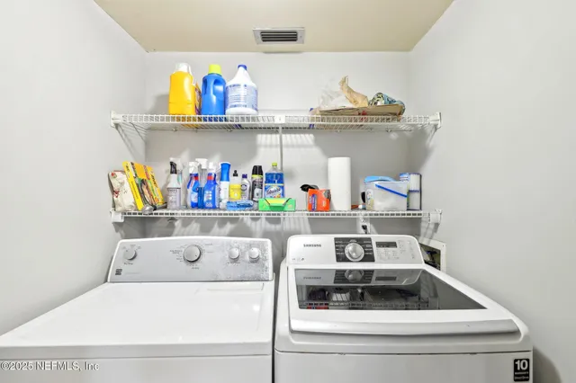 a backyard of a house with barbeque oven table and chairs