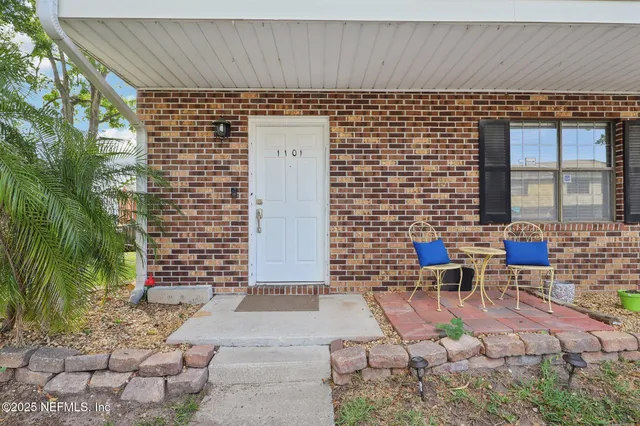 a brick building with a bench in front of it