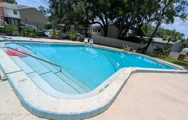 a view of a swimming pool with lounge chair